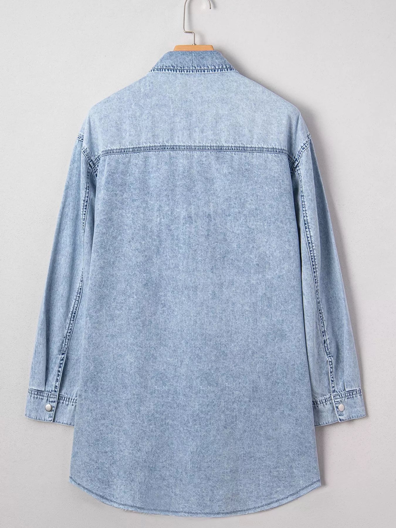 Light blue denim shirt dress with chest pocket and raw hem, loose fit, by Trendsi, casual and stylish for everyday wear.