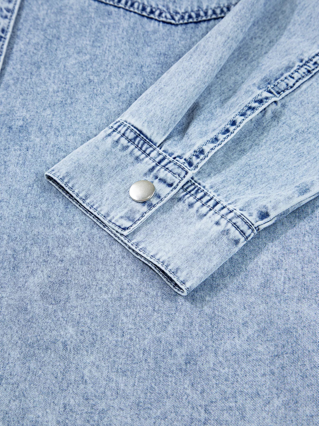 Light blue denim shirt dress with chest pockets and raw hem, featuring a loose fit and casual style by Trendsi.