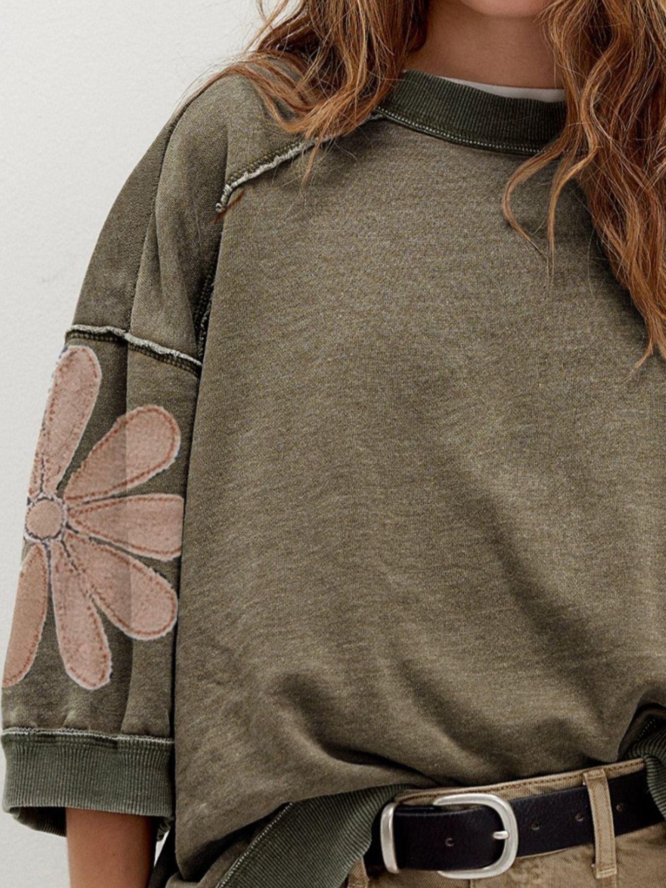 Mineral wash raw seam patchwork floral loose 3/4 sleeve top by Trendsi with patch details and relaxed fit.