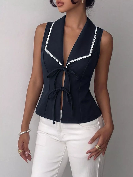 Navy blue lace trim tie-front vest from Trendsi, featuring a sleeveless design and delicate lace details in the front.