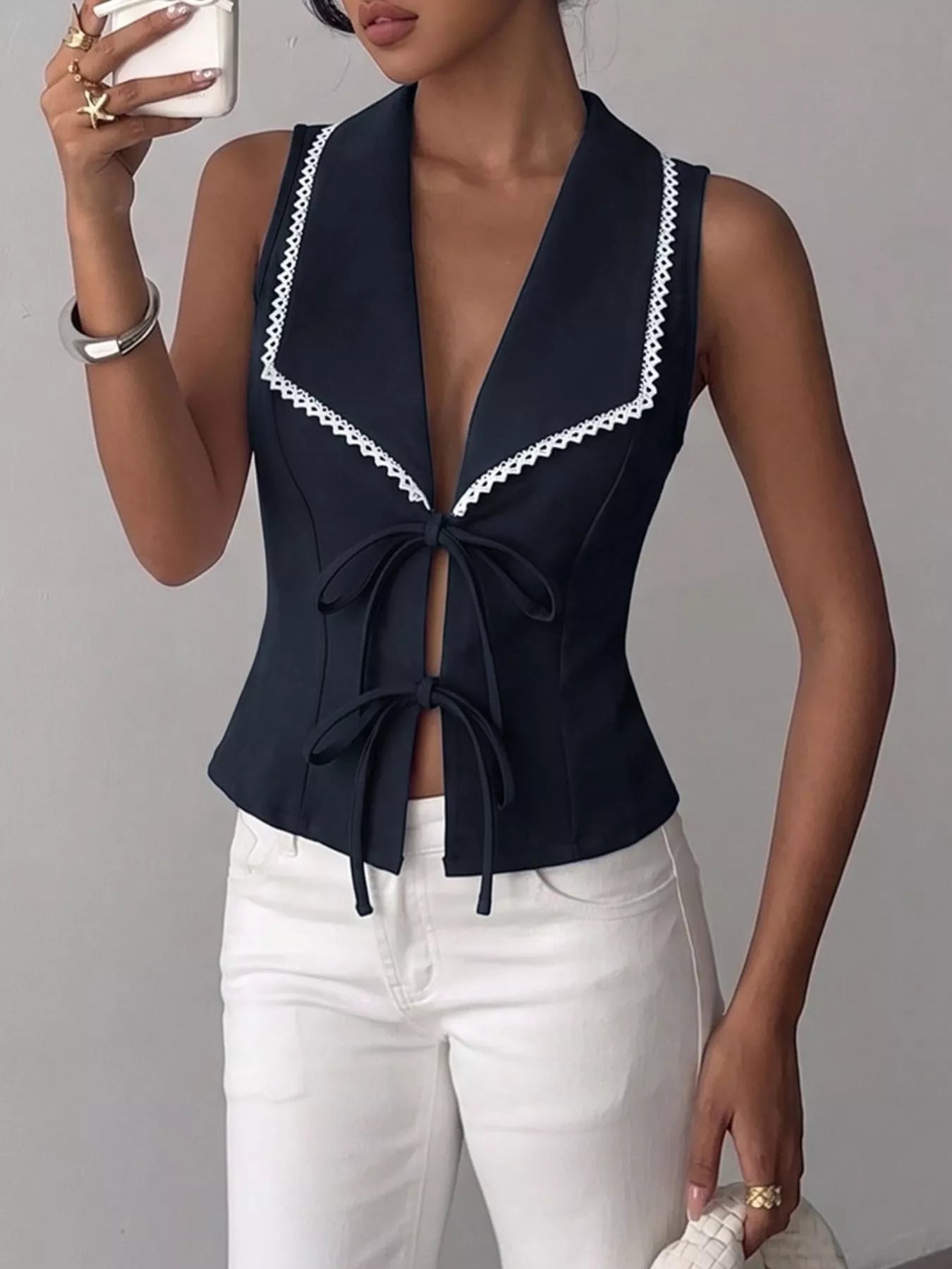 Navy blue lace trim tie-front vest by Trendsi, lightweight sleeveless design with delicate lace details and a front tie closure.