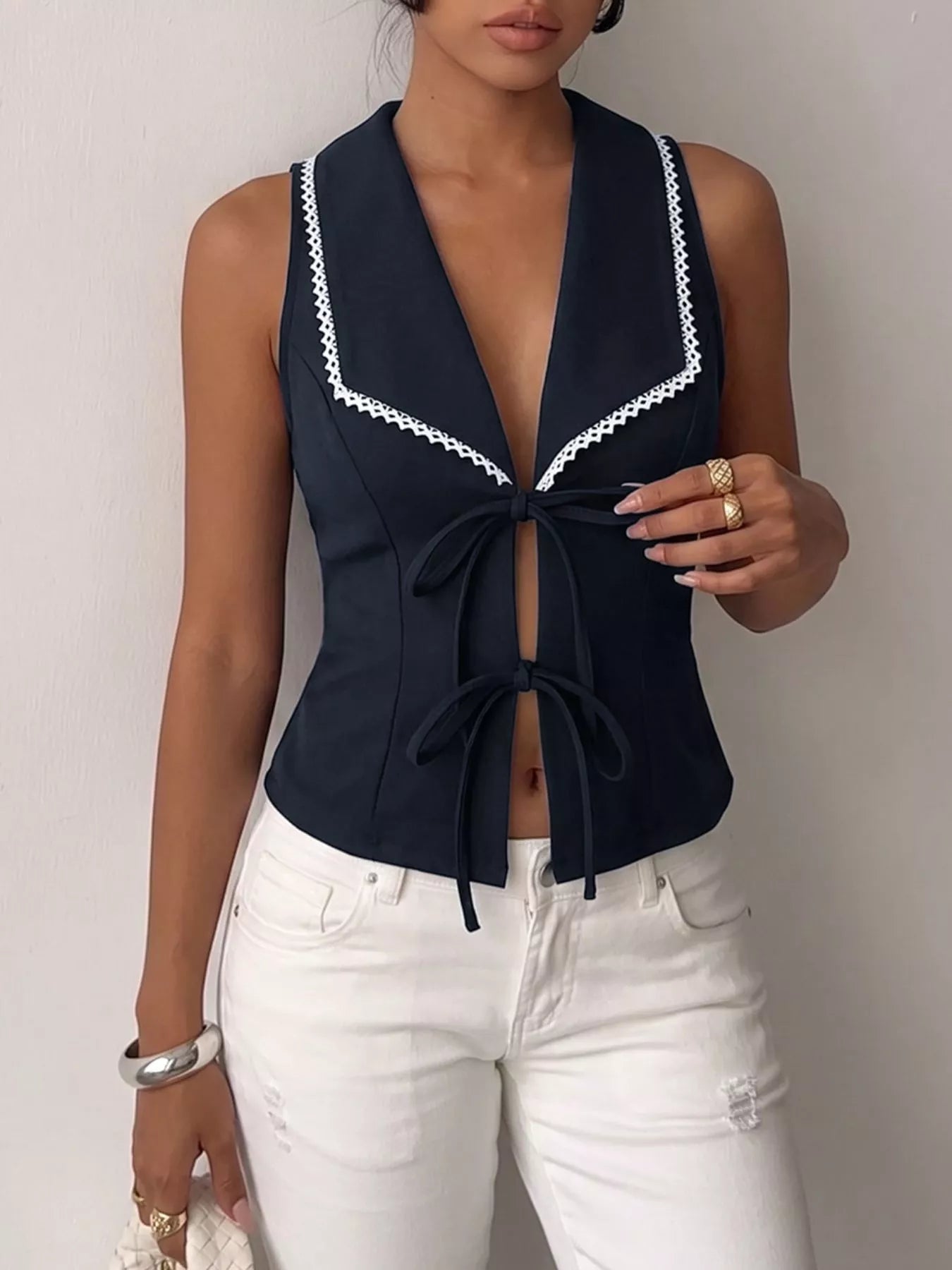 Navy blue lace trim tie-front vest from Trendsi, featuring a lightweight fabric and stylish front tie detail.