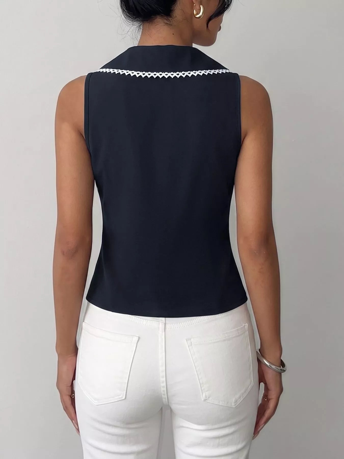 Navy blue lace trim tie-front vest by Trendsi, featuring a sleeveless design with delicate lace details and a adjustable front tie.