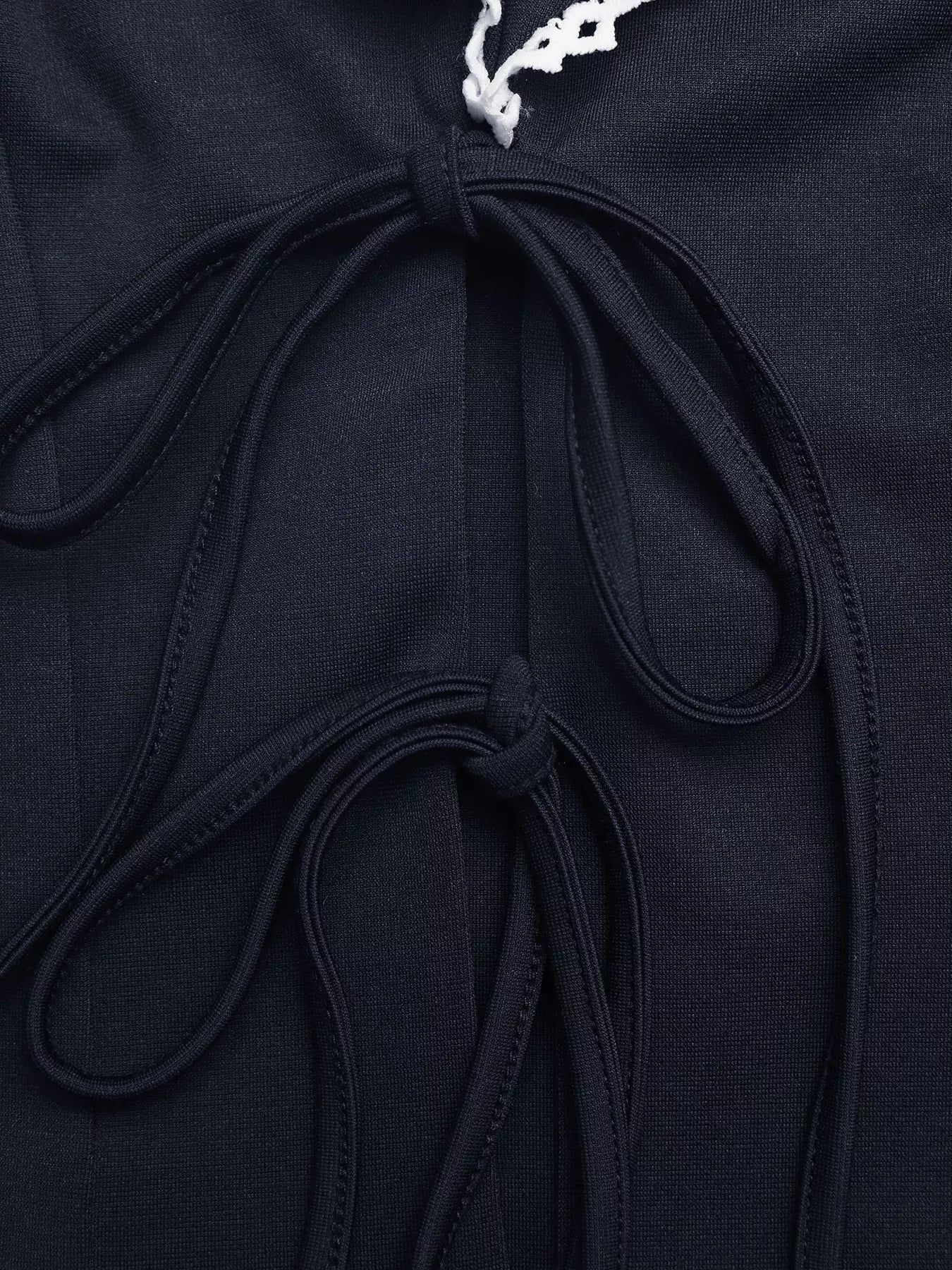Navy blue lace trim tie-front vest by Trendsi featuring a sleeveless design and delicate lace details on the front.