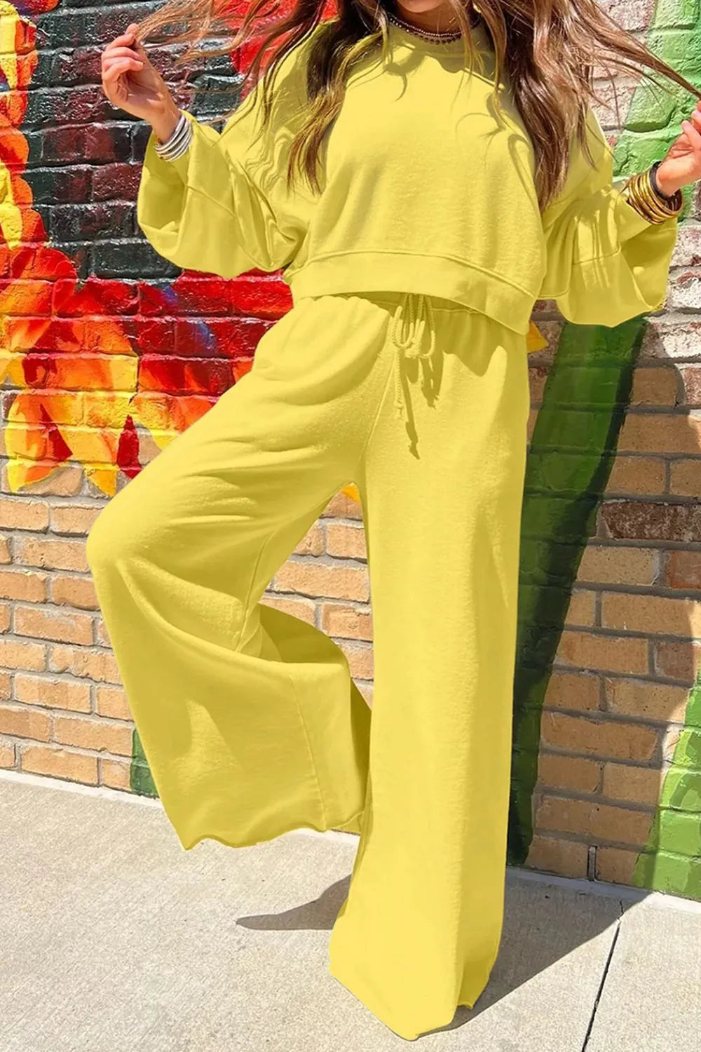 Yellow round neck long sleeve sweatshirt and pants set by Trendsi, casual loungewear with comfortable fit and modern style.
